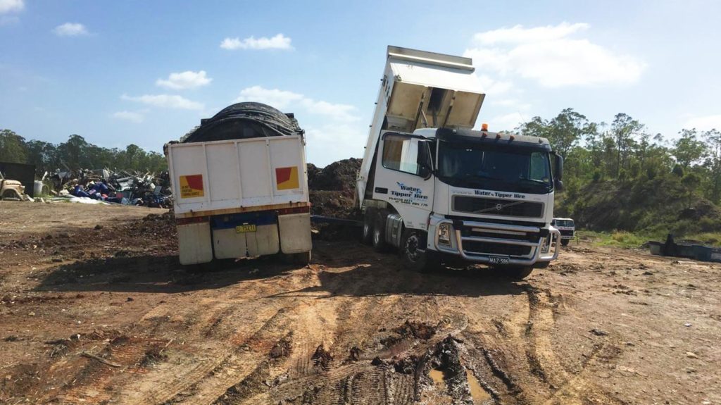GALLER IMAGE - Big Dump Truck dumping loads at tip
